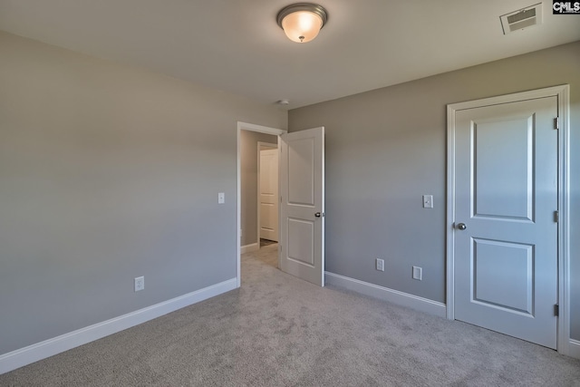 unfurnished bedroom with visible vents, baseboards, and carpet