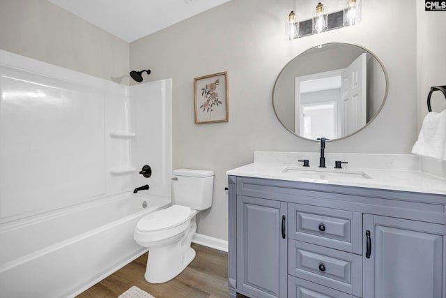 full bathroom with shower / tub combination, vanity, wood-type flooring, and toilet