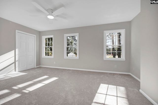 carpeted empty room with ceiling fan