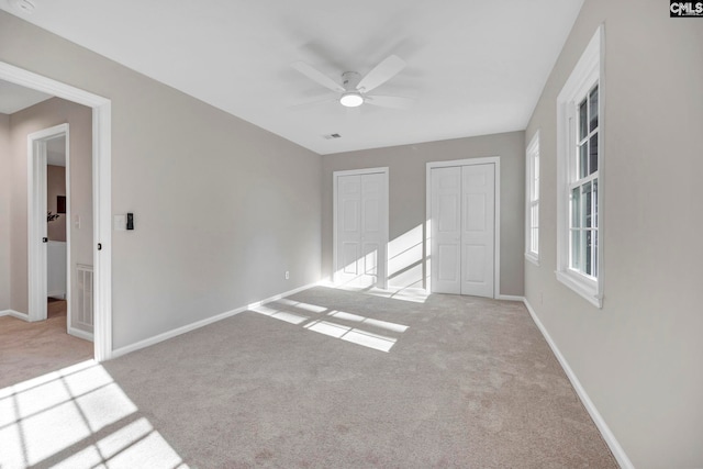 unfurnished room with ceiling fan and light colored carpet