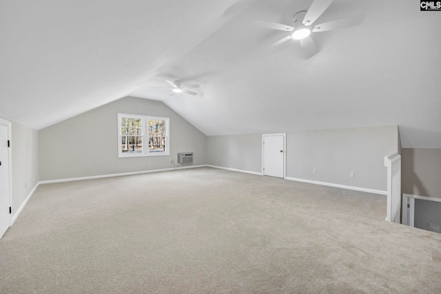 additional living space featuring light carpet, an AC wall unit, ceiling fan, and lofted ceiling