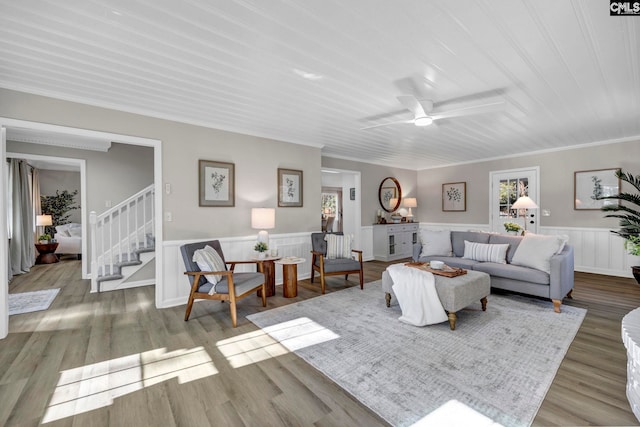 living room with ceiling fan, light hardwood / wood-style flooring, and ornamental molding