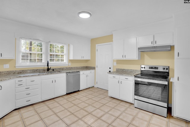 kitchen featuring white cabinets, appliances with stainless steel finishes, light stone counters, and sink