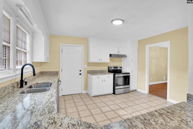 kitchen with white cabinets, sink, electric range, light tile patterned flooring, and light stone counters