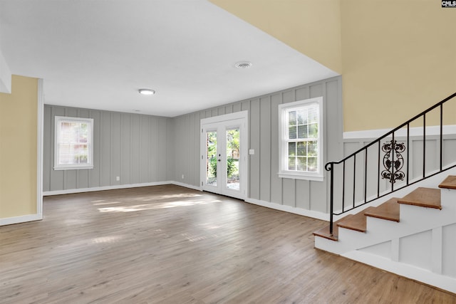 foyer entrance featuring hardwood / wood-style flooring and french doors