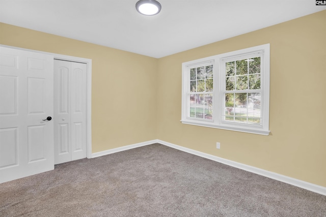 unfurnished bedroom with carpet floors and a closet