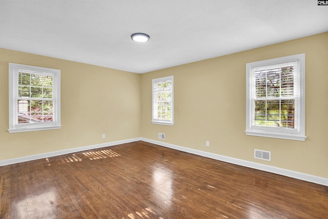 unfurnished room featuring hardwood / wood-style flooring