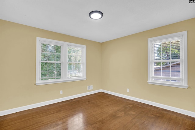 unfurnished room featuring hardwood / wood-style floors