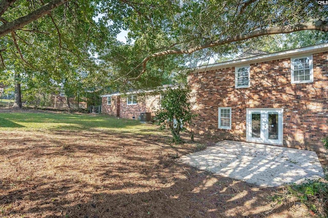 back of house featuring a patio area, a yard, and french doors