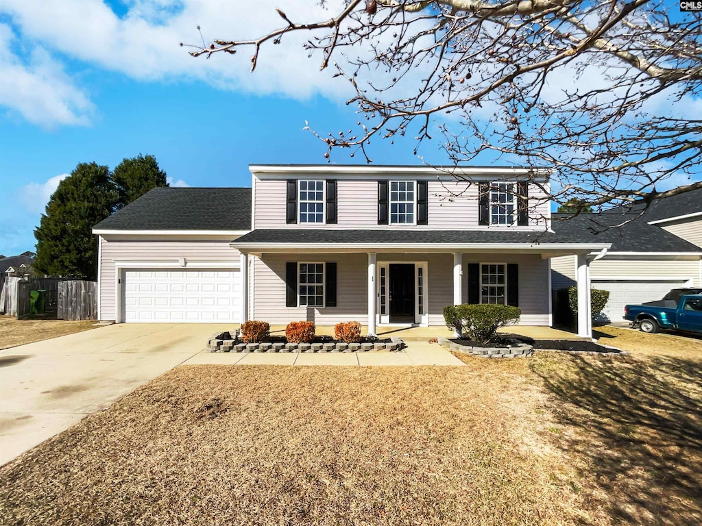 view of front of home featuring covered porch and a garage