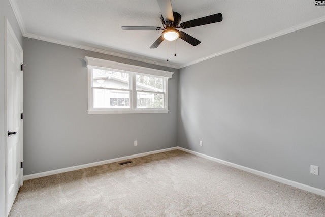 spare room with ceiling fan, carpet floors, and ornamental molding