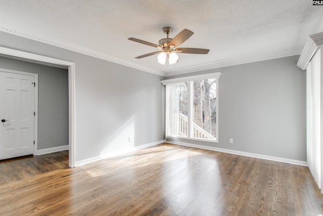 empty room featuring hardwood / wood-style floors, a textured ceiling, ceiling fan, and ornamental molding