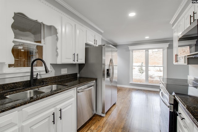 kitchen featuring sink, white cabinets, stainless steel appliances, and ornamental molding