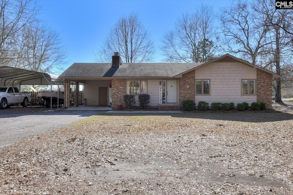 single story home featuring a carport