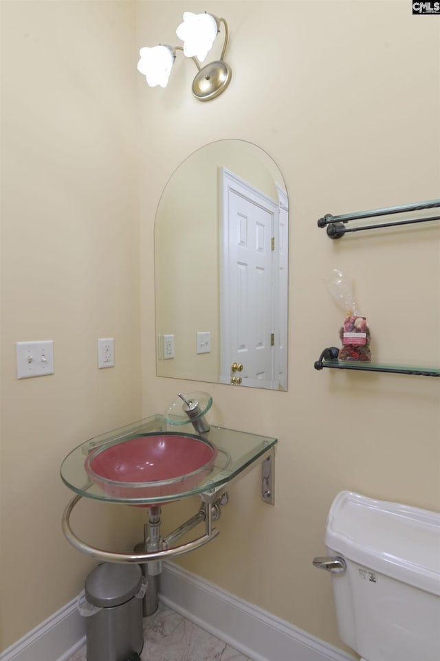 bathroom featuring toilet and sink