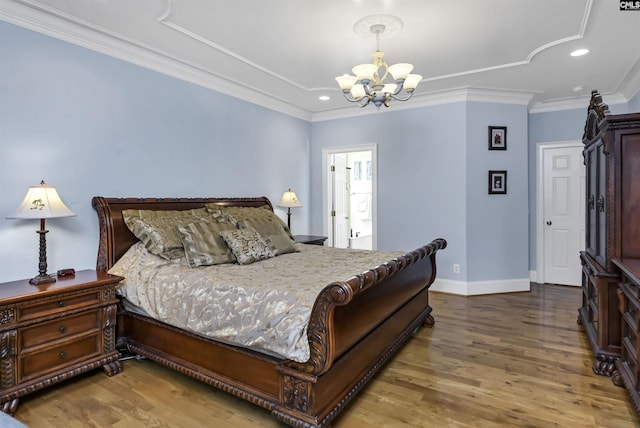 bedroom with crown molding, a chandelier, and hardwood / wood-style flooring