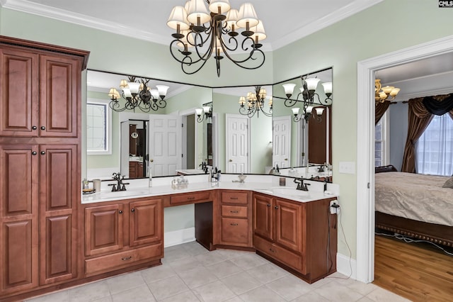 bathroom featuring crown molding, tile patterned flooring, vanity, and a chandelier