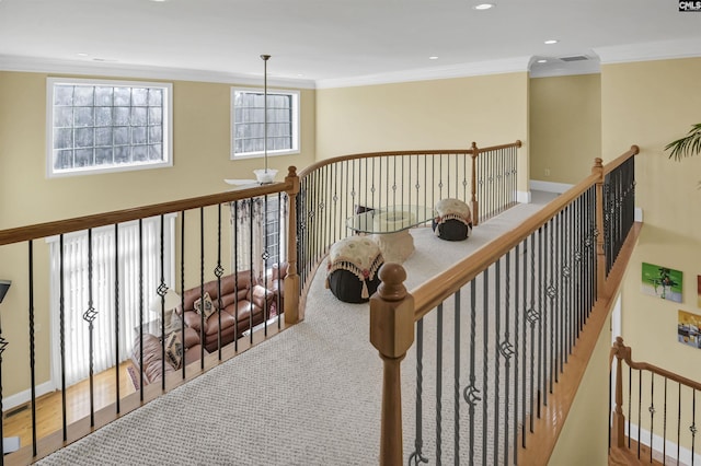 hallway featuring carpet floors and ornamental molding