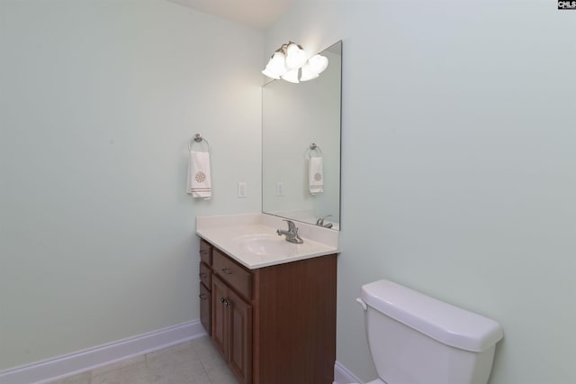 bathroom with tile patterned flooring, vanity, and toilet