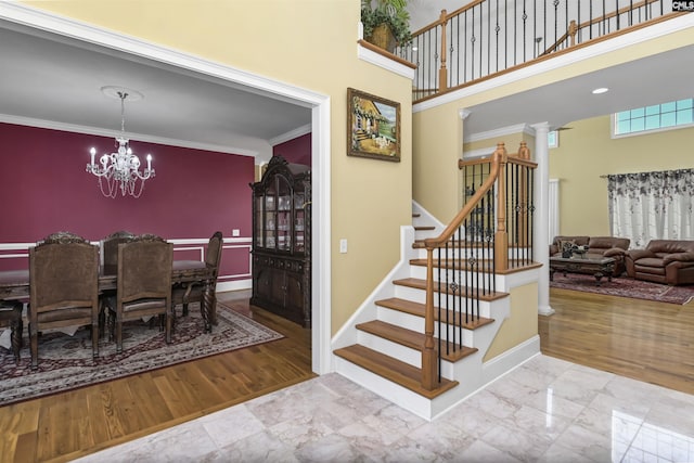 dining room with a notable chandelier, light hardwood / wood-style floors, and ornamental molding