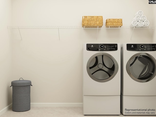 washroom with washing machine and dryer