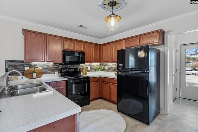 kitchen with pendant lighting, crown molding, sink, and black appliances