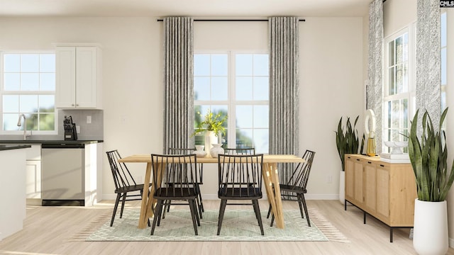 dining space featuring sink and light hardwood / wood-style flooring