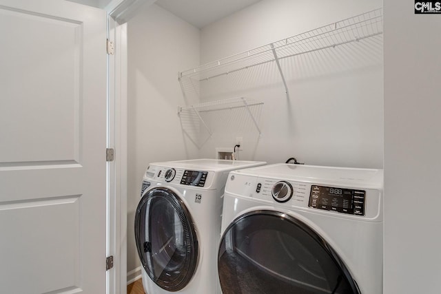 clothes washing area featuring washer and dryer