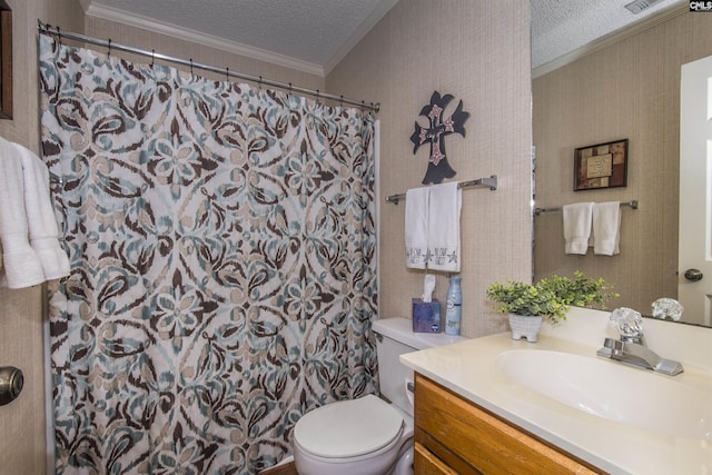 bathroom featuring vanity, toilet, ornamental molding, and a textured ceiling