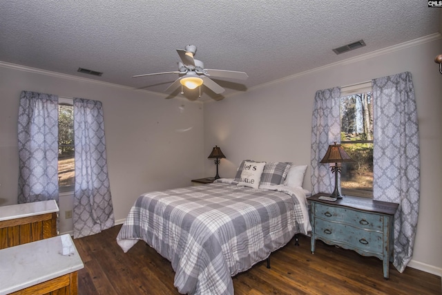 bedroom featuring a textured ceiling, ceiling fan, ornamental molding, and dark wood-type flooring