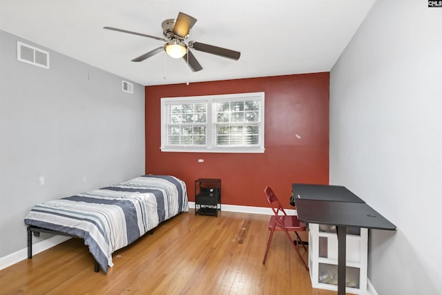 bedroom with ceiling fan and hardwood / wood-style flooring