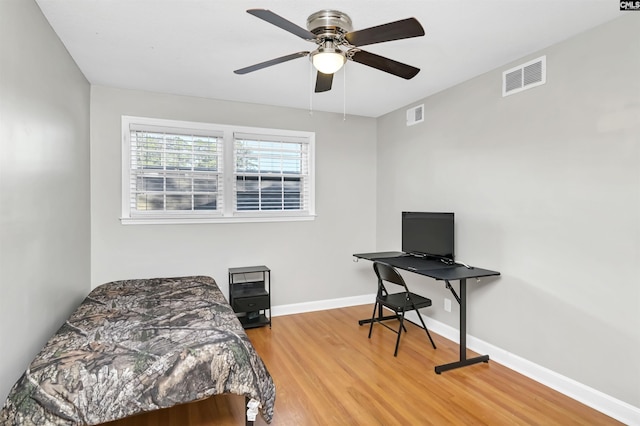 bedroom with hardwood / wood-style floors and ceiling fan