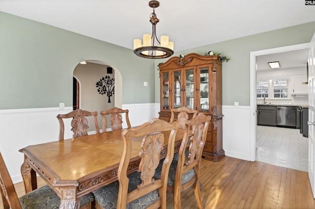 dining space featuring a chandelier and light wood-type flooring