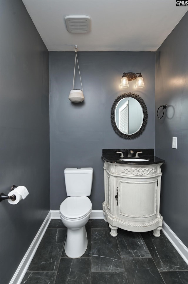 bathroom featuring vanity and toilet