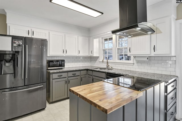 kitchen with island range hood, sink, white cabinetry, and stainless steel appliances