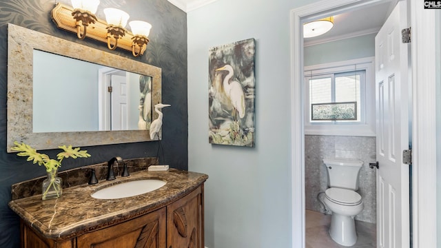 bathroom featuring tile patterned floors, vanity, toilet, and crown molding