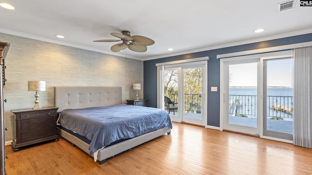 bedroom featuring ceiling fan, light hardwood / wood-style flooring, crown molding, access to outside, and a water view