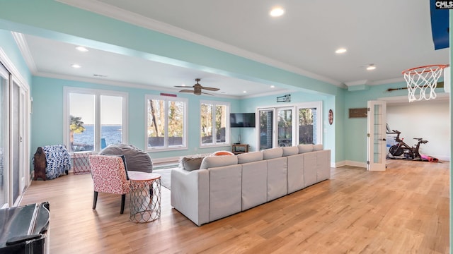 living room with light wood-type flooring and crown molding