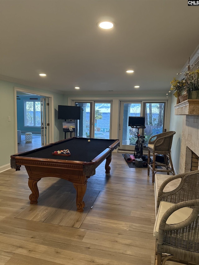 playroom with plenty of natural light, light hardwood / wood-style flooring, and billiards