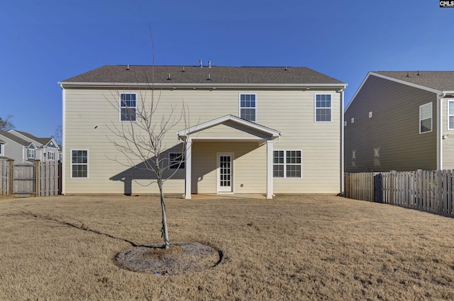 rear view of house with a yard