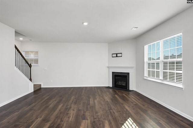 unfurnished living room with dark hardwood / wood-style floors