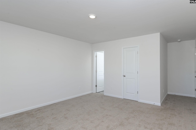 empty room featuring light carpet