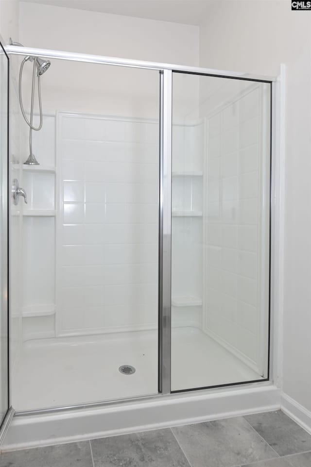 bathroom featuring a shower with door