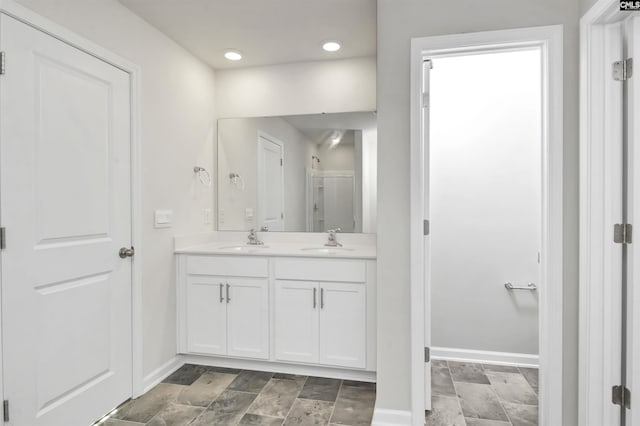 bathroom featuring vanity and a shower with shower door