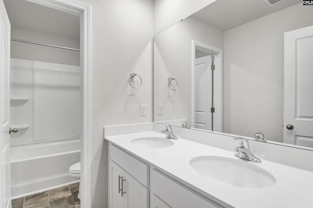 full bathroom with vanity,  shower combination, and toilet