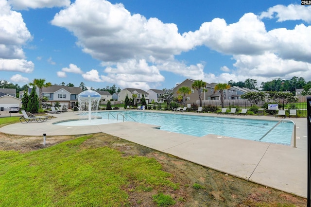 view of swimming pool featuring pool water feature and a patio