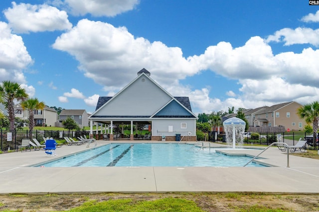 view of pool with pool water feature and a patio area