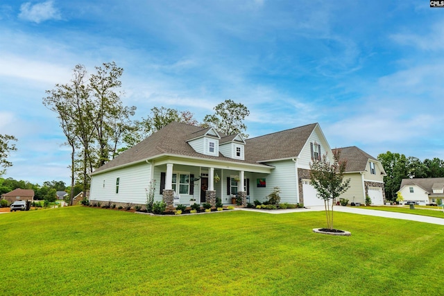 view of front of house featuring a front yard, a garage, and covered porch