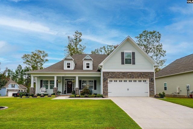 view of front of home featuring a front lawn, a porch, and a garage