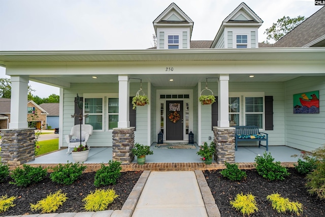 view of exterior entry with a porch